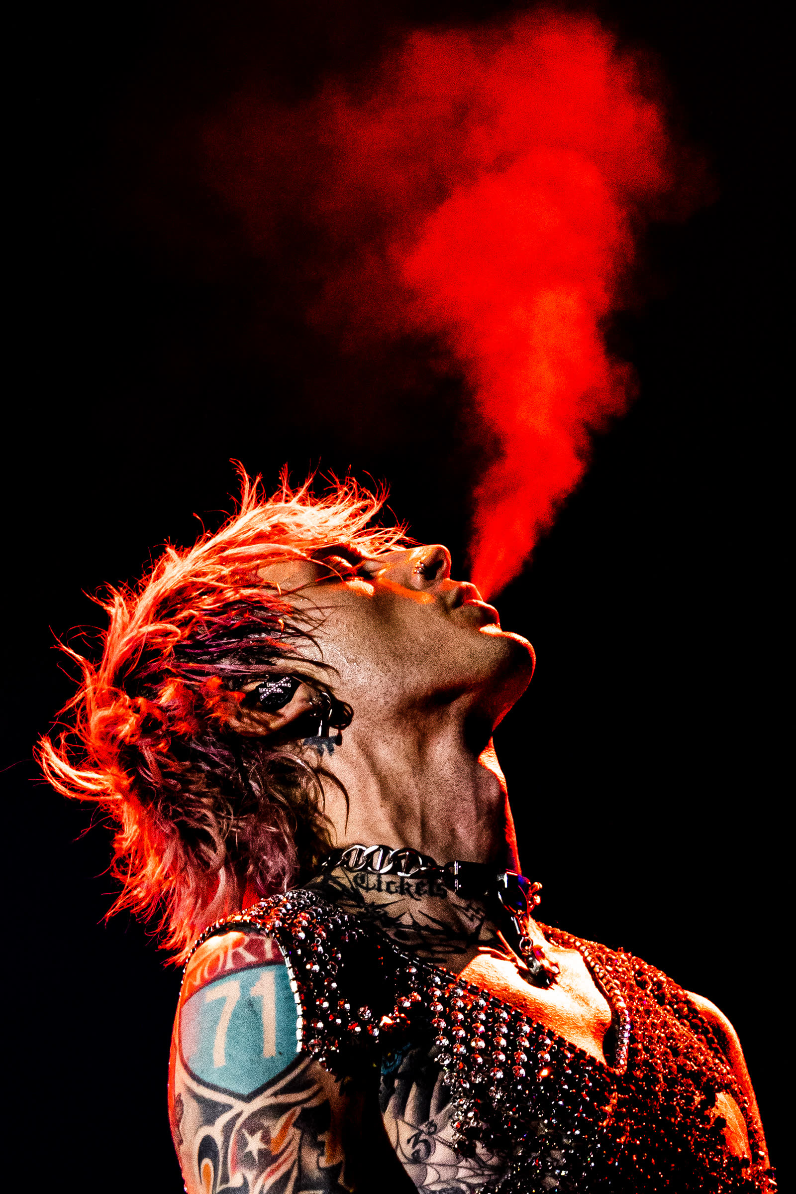 Head thrown back, a plume of red mist rising from his lips into the black, Mainstream Sellout tour.